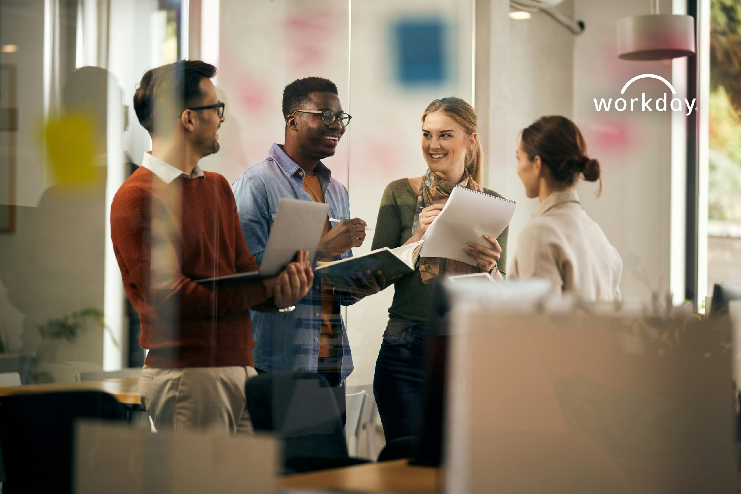 Group of young coworkers chatting in an office