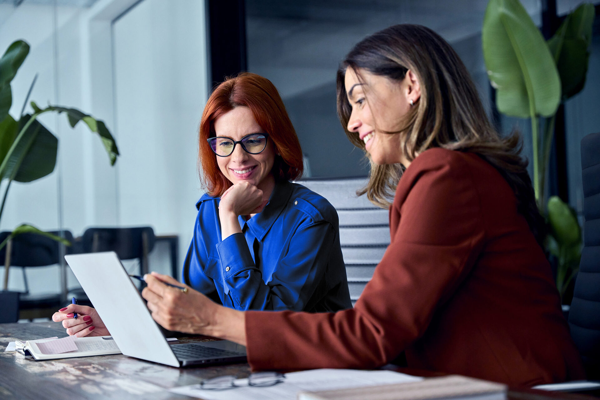 Two professionals collaborating on AI use case for financial close and reporting in office setting